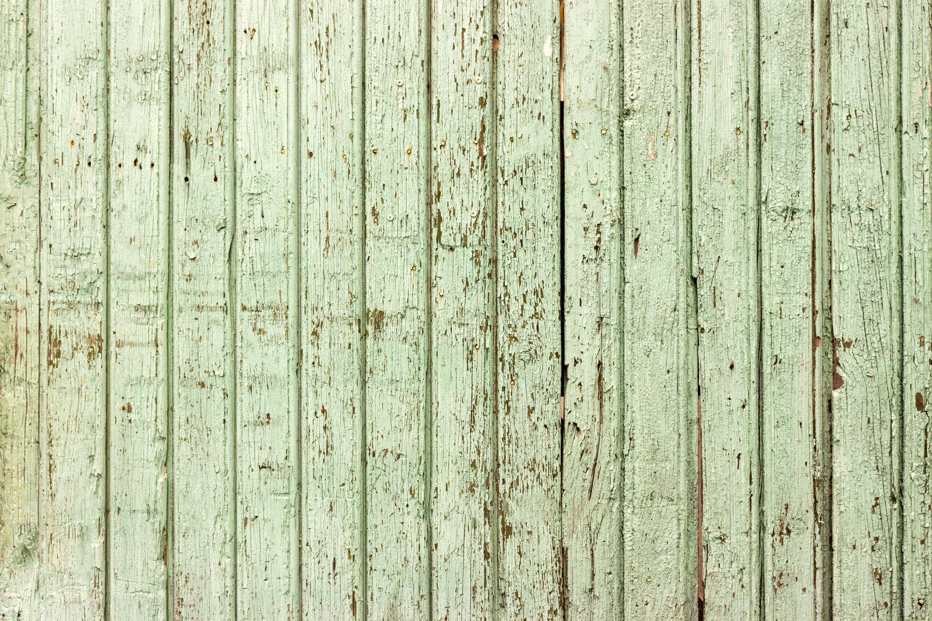 Bright Green Wooden Background with Peeling Paint and Vertical Boards